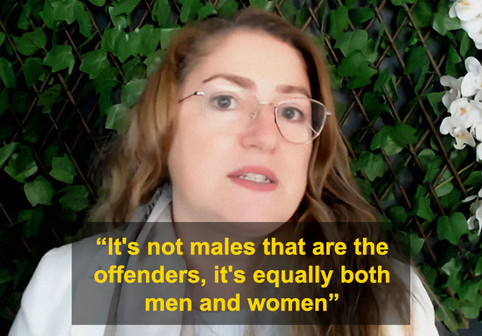 University professor discussing domestic violence claims that women commit violence as much as men in a debate setting. University professor discussing domestic violence claims that women commit violence as much as men in a debate setting.