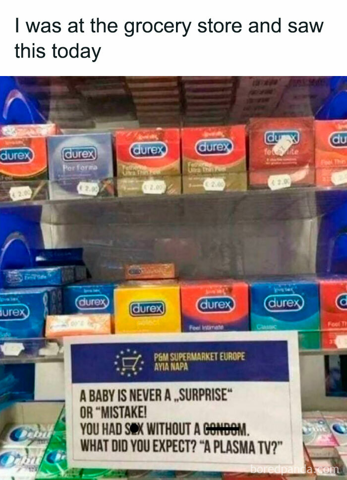 C****m display at grocery store with humorous sign about babies and contraceptive use, fitting silly relatable spicy memes theme.