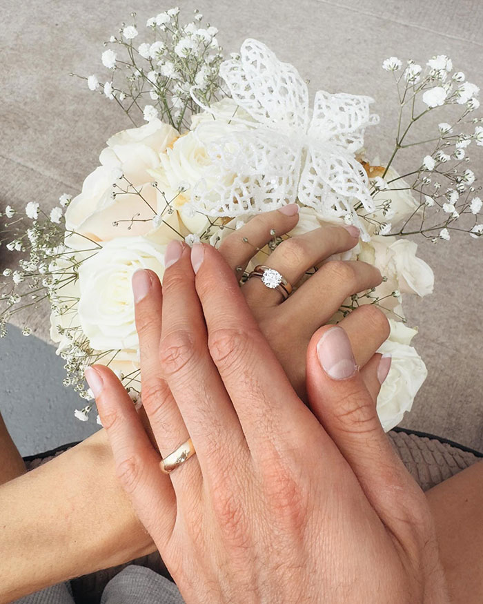 Hands with wedding rings over a white flower bouquet, symbolizing the union of 25 year-old pro boxer Georgia O’Connor. Hands with wedding rings over a white flower bouquet, symbolizing the union of 25 year-old pro boxer Georgia O’Connor.