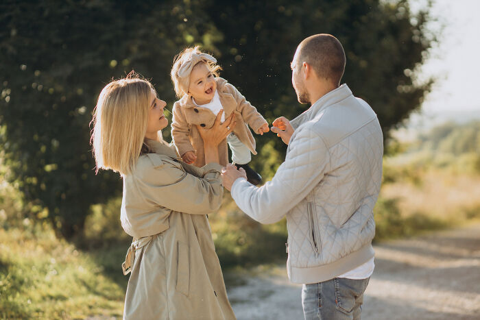 Young family enjoying outdoors with a baby, capturing moments of life after men who lost amazing partners cope and adapt.