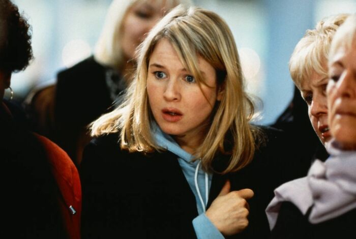 Blonde woman with a concerned expression in a crowd, featured in a challenge for real movie fans to name actors. Blonde woman with a concerned expression in a crowd, featured in a challenge for real movie fans to name actors.