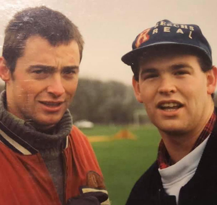 Two young men outdoors with one wearing a cap, related to Hugh Jackman’s childhood friend discussing actor's divorce. Two young men outdoors with one wearing a cap, related to Hugh Jackman’s childhood friend discussing actor's divorce.