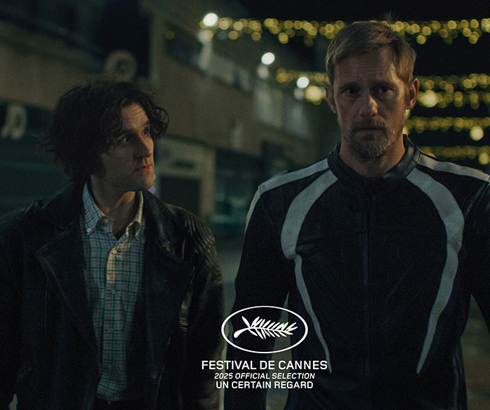 Two men in dark clothing stand outside at night with Festival de Cannes 2025 official selection logo visible on screen. Two men in dark clothing stand outside at night with Festival de Cannes 2025 official selection logo visible on screen.