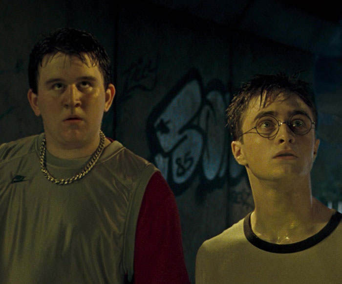 Two young men in a dark urban setting, featuring a Harry Potter star in a scene from an X-rated gay film. Two young men in a dark urban setting, featuring a Harry Potter star in a scene from an X-rated gay film.