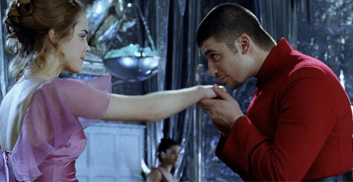 Actor who played Viktor Krum in Harry Potter seen in a scene at the Yule Ball wearing a red outfit and kissing a woman's hand. Actor who played Viktor Krum in Harry Potter seen in a scene at the Yule Ball wearing a red outfit and kissing a woman's hand.