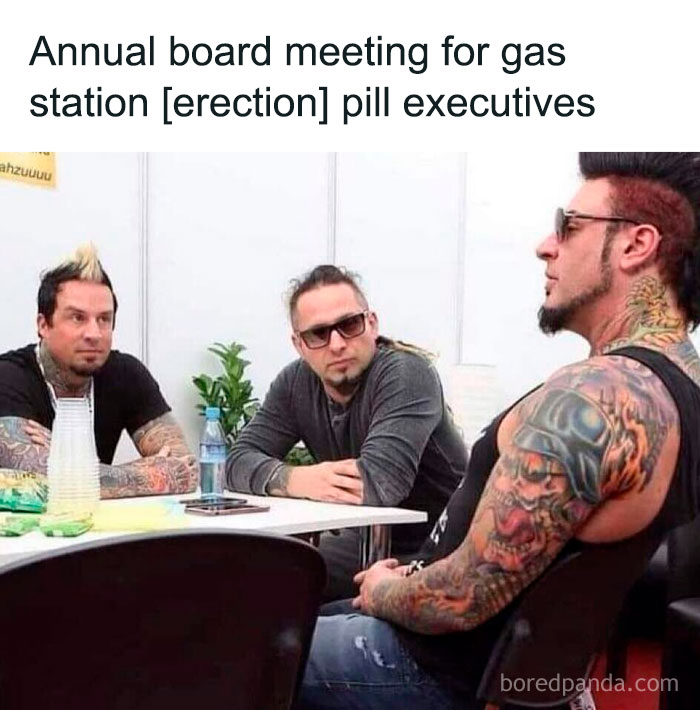 Three heavily tattooed men with mohawks sitting at a table during a funny and relatable meme meeting.