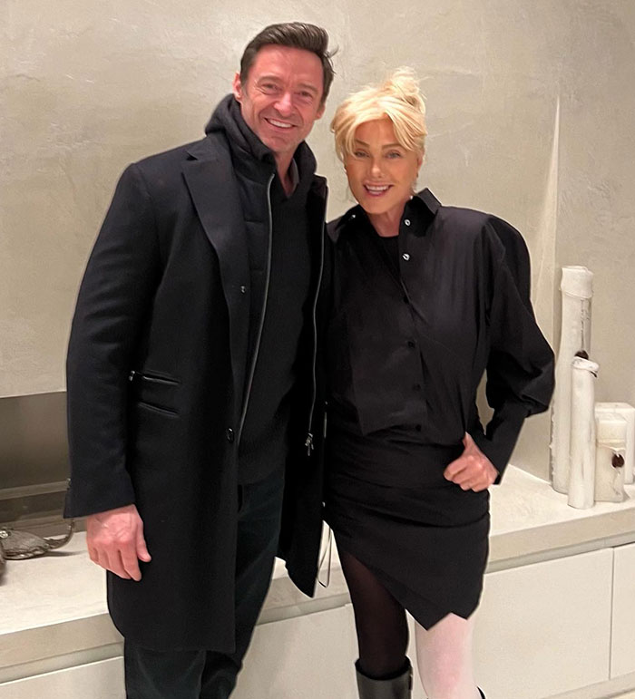 Hugh Jackman and a woman posing indoors, dressed in black outfits, related to actor's divorce news discussion. Hugh Jackman and a woman posing indoors, dressed in black outfits, related to actor's divorce news discussion.