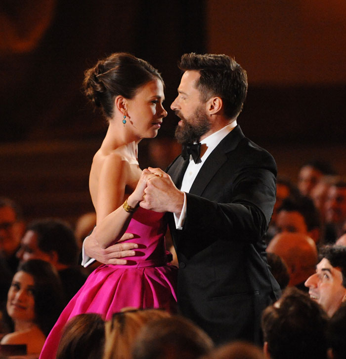 Hugh Jackman and Sutton Foster dancing at an event, showcasing their long history in the entertainment industry. Hugh Jackman and Sutton Foster dancing at an event, showcasing their long history in the entertainment industry.
