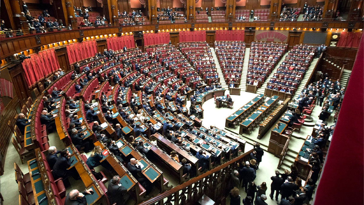 Large legislative chamber filled with attendees, illustrating industry secrets revealed behind closed doors in a formal setting.