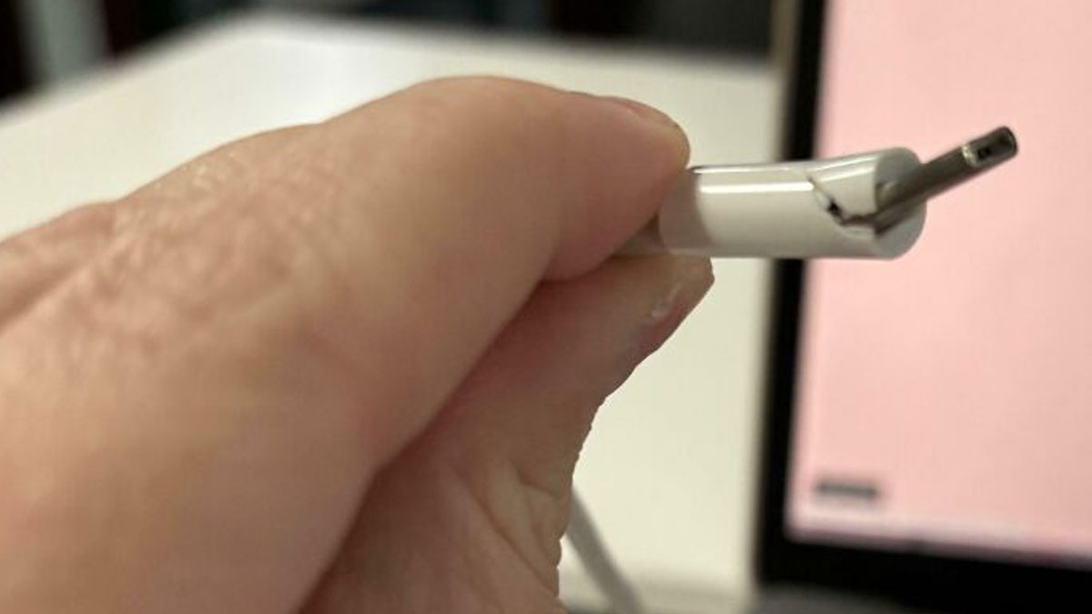 Close-up of a hand holding a frayed charging cable showing what mildly infuriated people shared that ruined their mood.