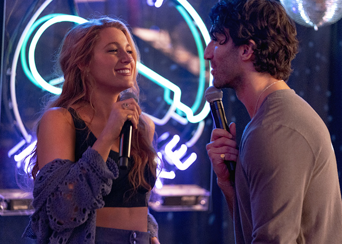 Blake Lively and a man holding microphones in a neon-lit setting, related to Ryan Reynolds and Scarlett Johansson lawsuit news. Blake Lively and a man holding microphones in a neon-lit setting, related to Ryan Reynolds and Scarlett Johansson lawsuit news.