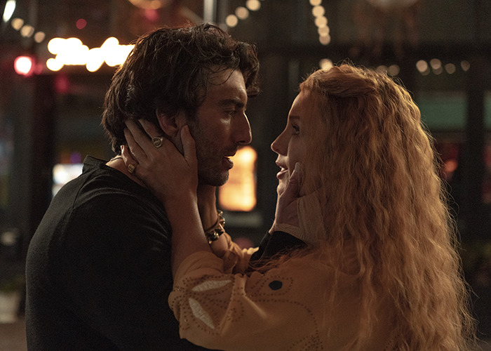 Couple sharing an intimate moment in dim light, representing Scarlett Johansson breaking silence on Ryan Reynolds and Blake Lively lawsuit. Couple sharing an intimate moment in dim light, representing Scarlett Johansson breaking silence on Ryan Reynolds and Blake Lively lawsuit.