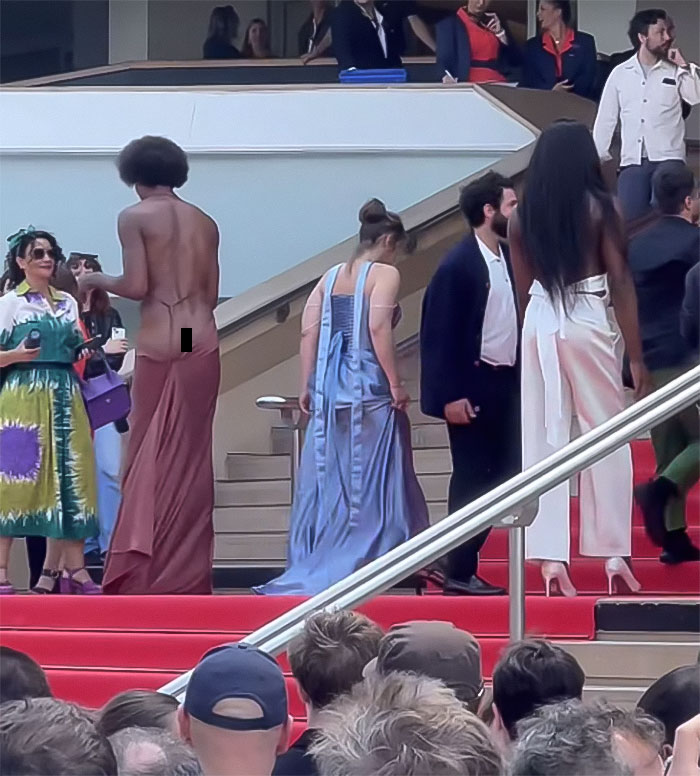 Star revealing backside on the Cannes red carpet breaking dress code, drawing attention and mass applause from the crowd. Star revealing backside on the Cannes red carpet breaking dress code, drawing attention and mass applause from the crowd.