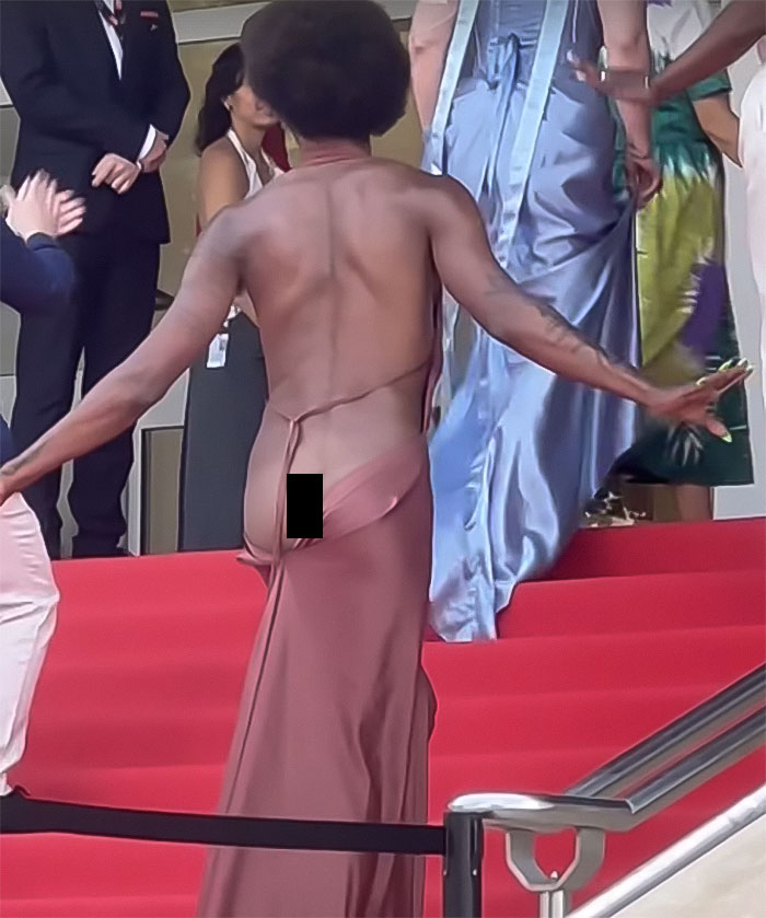 Star reveals backside on red carpet, breaking Cannes dress code while crowd applauds at glamorous event. Star reveals backside on red carpet, breaking Cannes dress code while crowd applauds at glamorous event.
