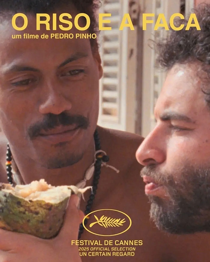 Two men sharing a moment with fruit, promoting a Cannes film, highlighting star reveals backside at Festival de Cannes. Two men sharing a moment with fruit, promoting a Cannes film, highlighting star reveals backside at Festival de Cannes.