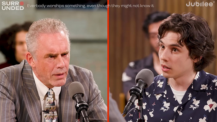 Jordan Peterson in a debate with atheists, speaking passionately during a recorded discussion event. Jordan Peterson in a debate with atheists, speaking passionately during a recorded discussion event.