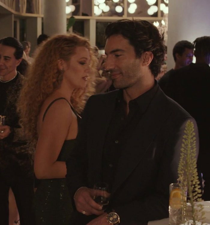 Blake Lively at a social event, engaging in conversation amid rumors of blackmail involving Taylor Swift. Blake Lively at a social event, engaging in conversation amid rumors of blackmail involving Taylor Swift.