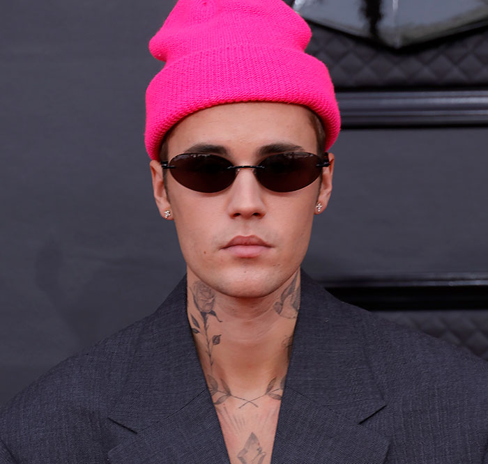 Justin Bieber wearing a bright pink beanie and black sunglasses, addressing rumors during trial day five. Justin Bieber wearing a bright pink beanie and black sunglasses, addressing rumors during trial day five.
