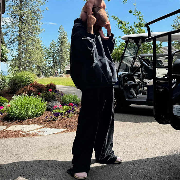 Justin Bieber carrying his son on shoulders outdoors, sparking a fiery parenting debate over smoking. Justin Bieber carrying his son on shoulders outdoors, sparking a fiery parenting debate over smoking.