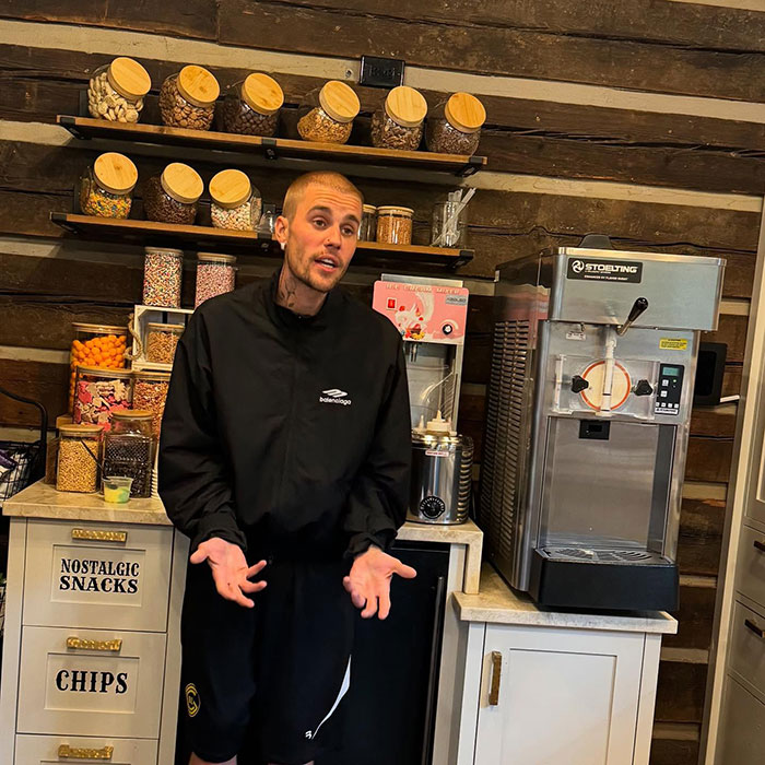 Justin Bieber standing in a snack shop kitchen, triggering fiery parenting debate over smoking with his son. Justin Bieber standing in a snack shop kitchen, triggering fiery parenting debate over smoking with his son.