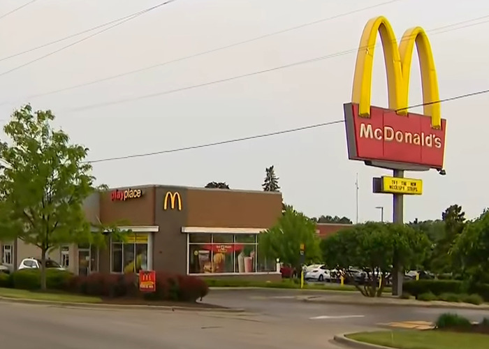 McDonald's exterior with large golden arches sign, related to story of lesbian attacked over bathroom use. McDonald's exterior with large golden arches sign, related to story of lesbian attacked over bathroom use.