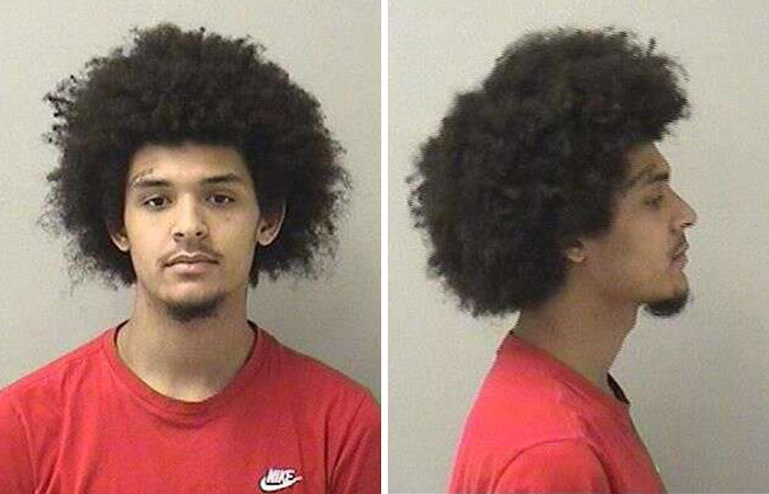 Mugshot of a young man with an afro hairstyle wearing a red Nike shirt related to the case of lesbian attacked at McDonald's restroom. Mugshot of a young man with an afro hairstyle wearing a red Nike shirt related to the case of lesbian attacked at McDonald's restroom.
