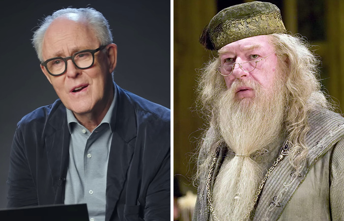 Older man with glasses speaking in interview next to a character resembling Dumbledore from Harry Potter series. Older man with glasses speaking in interview next to a character resembling Dumbledore from Harry Potter series.