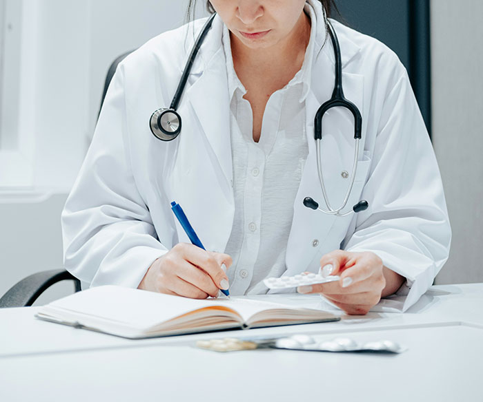 Woman medical professional holding pills and writing notes, illustrating change after losing pretty privilege concept. Woman medical professional holding pills and writing notes, illustrating change after losing pretty privilege concept.