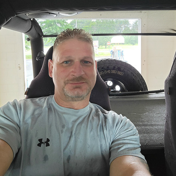 Man in a light gray shirt sitting inside a vehicle, related to Ashish Yadav dad fatally beaten with metal bat news. Man in a light gray shirt sitting inside a vehicle, related to Ashish Yadav dad fatally beaten with metal bat news.