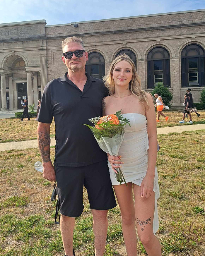 Man and young woman standing outside a school building, with the man identified as dad fatally beaten with metal bat. Man and young woman standing outside a school building, with the man identified as dad fatally beaten with metal bat.