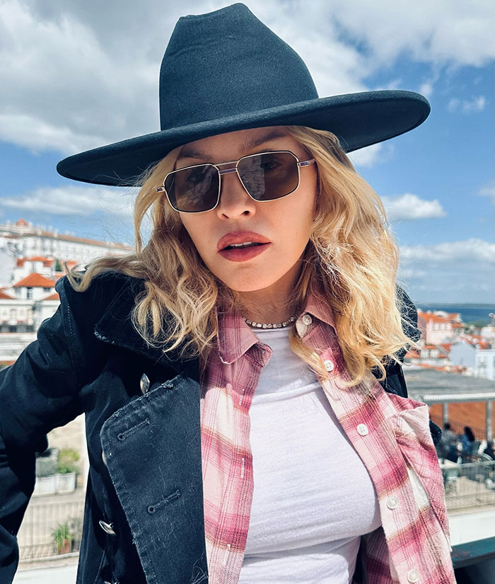 Madonna wearing sunglasses and a hat outdoors, fans notice the missing famous gap from her face. Madonna wearing sunglasses and a hat outdoors, fans notice the missing famous gap from her face.