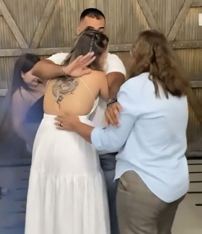 Man pushes mom away during baby gender reveal celebration with wife, causing tension among family members at event. Man pushes mom away during baby gender reveal celebration with wife, causing tension among family members at event.