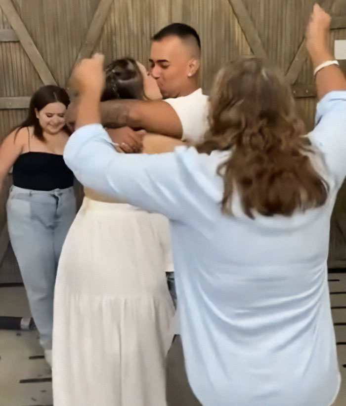 Man pushing mom away while celebrating baby's gender reveal with wife, capturing tense family moment during event. Man pushing mom away while celebrating baby's gender reveal with wife, capturing tense family moment during event.