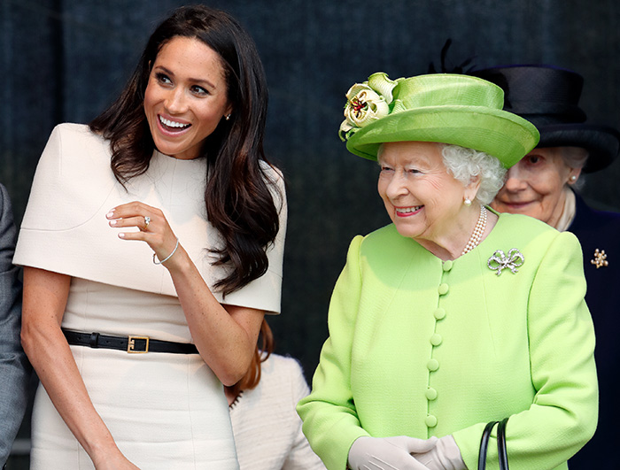 Meghan Markle smiling next to Queen Elizabeth in a bright outfit, related to wedding caterer controversy and royal intervention. Meghan Markle smiling next to Queen Elizabeth in a bright outfit, related to wedding caterer controversy and royal intervention.