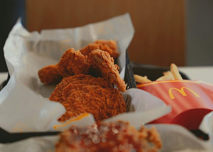 Fried chicken and fries from a fast food meal, highlighting concerns about kids being fed unhealthy fast food. Fried chicken and fries from a fast food meal, highlighting concerns about kids being fed unhealthy fast food.