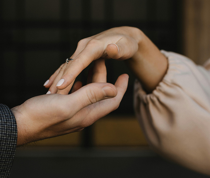 Close-up of couple holding hands, focusing on wedding ring, symbolizing wedding drama and loyalty test conflict. Close-up of couple holding hands, focusing on wedding ring, symbolizing wedding drama and loyalty test conflict.