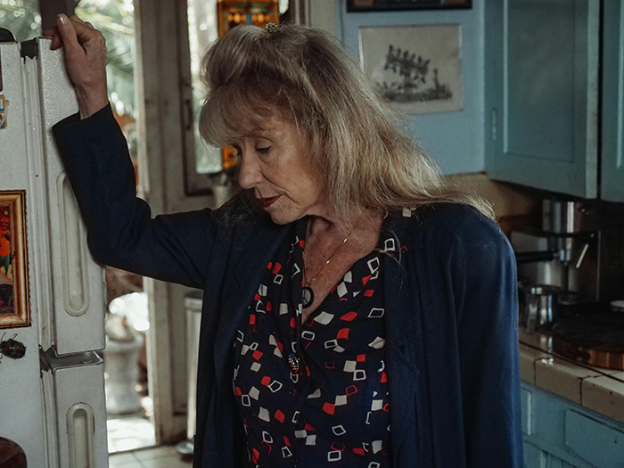 Older woman in a kitchen looking distressed, portraying wedding drama after groom fails fiancée loyalty test. Older woman in a kitchen looking distressed, portraying wedding drama after groom fails fiancée loyalty test.