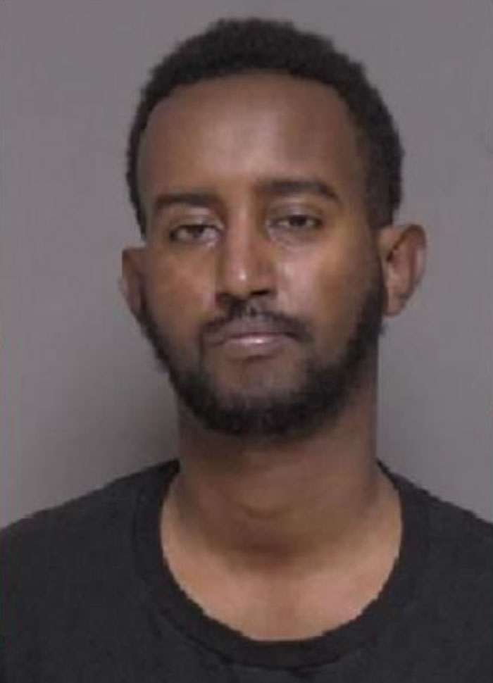 Mugshot of a man with a serious expression, related to a case involving a racist woman and playground incident. Mugshot of a man with a serious expression, related to a case involving a racist woman and playground incident.