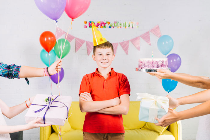 Young boy celebrating birthday party with balloons and gifts, highlighting nephew excluded from son's birthday controversy. Young boy celebrating birthday party with balloons and gifts, highlighting nephew excluded from son's birthday controversy.