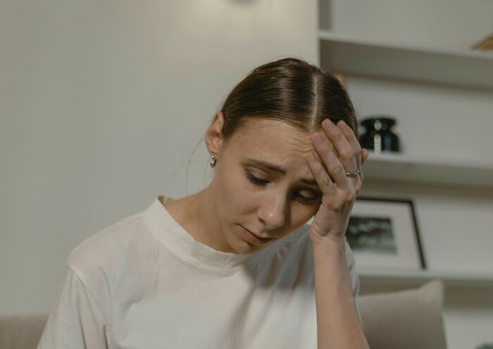 Young woman looking worried at home, reflecting on daughter's support for grieving mom's new romance concerns.