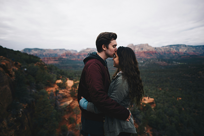 Couple embracing outdoors with scenic background, partner comforting upset girlfriend with strawberry allergy concerns. Couple embracing outdoors with scenic background, partner comforting upset girlfriend with strawberry allergy concerns.