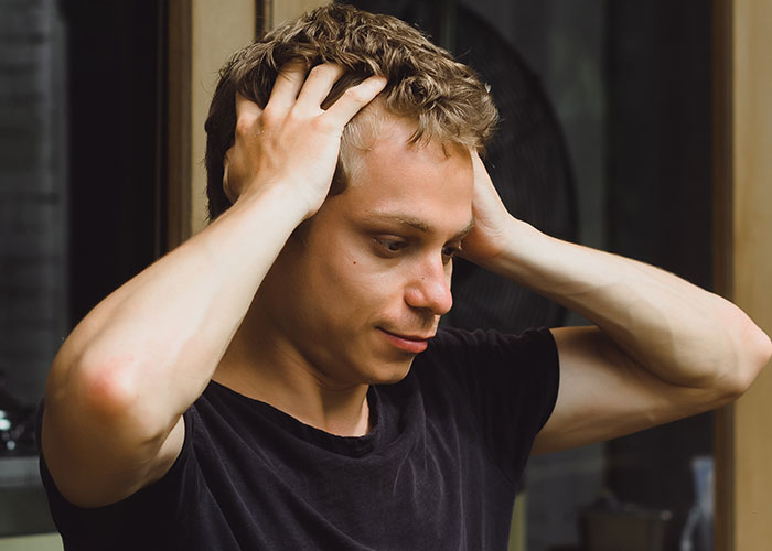 Young man frustrated and stressed as boss tells workers their pay is late after showing off new truck. Young man frustrated and stressed as boss tells workers their pay is late after showing off new truck.