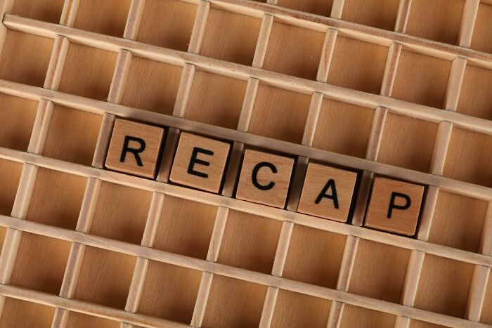 Wooden letter tiles spelling recap on a wooden tray, related to decoding slang words from the 1920s. Wooden letter tiles spelling recap on a wooden tray, related to decoding slang words from the 1920s.