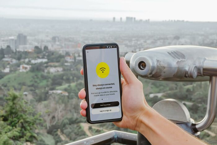Hand holding smartphone with a connectivity app displayed, showing a tiny thing that made the trip better view.