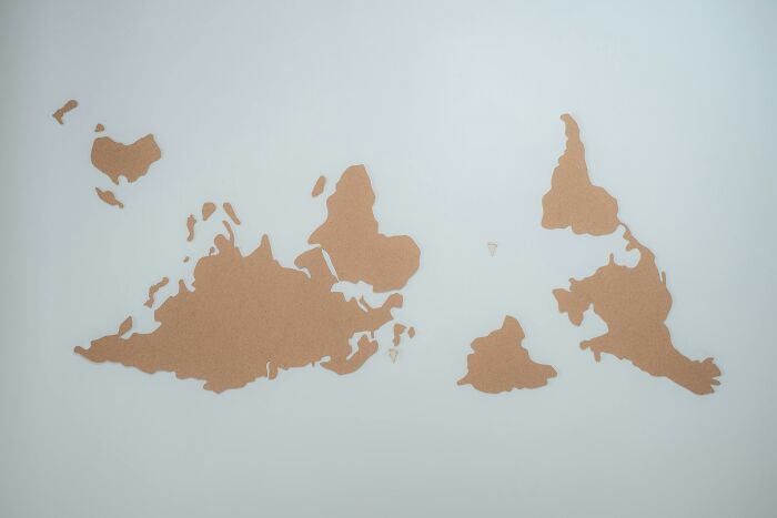 Upside down world map with continents in brown on a white background, challenging viewers to name countries. Upside down world map with continents in brown on a white background, challenging viewers to name countries.