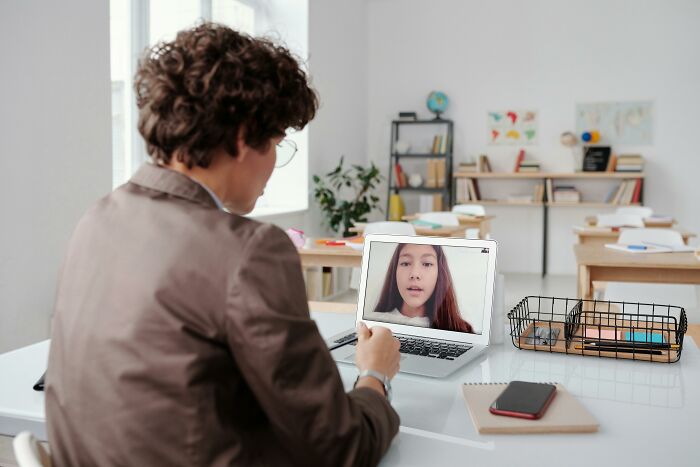 Person attending a virtual meeting on laptop in an empty classroom about teacher appreciation week deals and offers. Person attending a virtual meeting on laptop in an empty classroom about teacher appreciation week deals and offers.