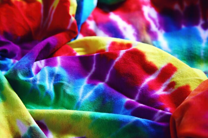 Close-up of colorful tie-dye fabric showcasing vibrant hues and patterns related to absurd things people were told growing up.