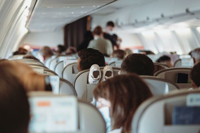 Passengers on a crowded airplane exhibiting common habits that are pure annoyance for flight attendants during the flight. Passengers on a crowded airplane exhibiting common habits that are pure annoyance for flight attendants during the flight.