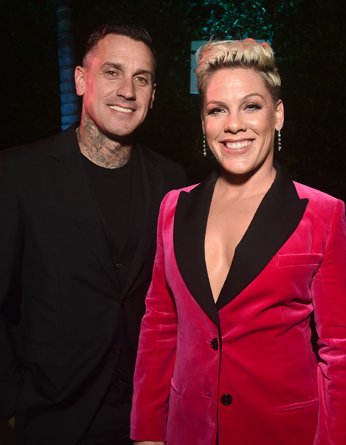 Pink and her husband at an event, highlighting Pink's husband sharing graphic post surgery bike accident updates.