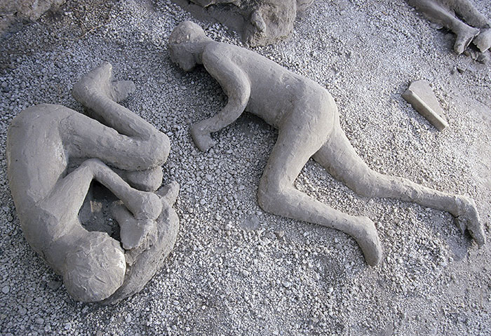 Plaster casts of victims at Pompeii, showing parents' tragic attempt to shield child during volcanic eruption. Plaster casts of victims at Pompeii, showing parents' tragic attempt to shield child during volcanic eruption.